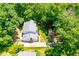 Aerial view of a home surrounded by mature trees, with a long driveway and well-maintained lawn at 2107 Somers Ave, Burlington, NC 27215