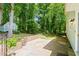 This backyard features a brick border, concrete patio, and privacy from a natural tree line at 2107 Somers Ave, Burlington, NC 27215