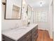 Bright bathroom featuring a double vanity with marble countertop and a walk-in closet in the background at 2107 Somers Ave, Burlington, NC 27215