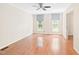 Bright bedroom with hardwood floors, neutral walls, ceiling fan and natural light at 2107 Somers Ave, Burlington, NC 27215