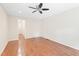 Minimalist bedroom with hardwood floors, neutral walls, and ceiling fan at 2107 Somers Ave, Burlington, NC 27215