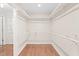 Walk-in closet with wooden floor and white shelving provides ample storage space at 2107 Somers Ave, Burlington, NC 27215