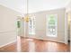 Dining area with hardwood floors, natural light, and an elegant chandelier at 2107 Somers Ave, Burlington, NC 27215