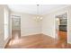 Spacious dining room with hardwood floors and an elegant chandelier at 2107 Somers Ave, Burlington, NC 27215