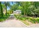 Traditional home with a long driveway surrounded by lush trees and an inviting, verdant lawn at 2107 Somers Ave, Burlington, NC 27215