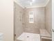 Modern shower with glass enclosure, gray tile, and a built-in bench creates a spa-like retreat at 2107 Somers Ave, Burlington, NC 27215