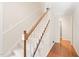 Traditional staircase with carpeted steps, a wooden banister, and light walls at 2107 Somers Ave, Burlington, NC 27215