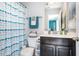 Bathroom featuring a shower with a blue shower curtain and a vanity with a dark wood cabinet at 217 Jones Hill Rd, Holly Springs, NC 27540