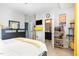 Bright bedroom with a view to the ensuite bathroom; cheerful yellow and white color scheme at 217 Jones Hill Rd, Holly Springs, NC 27540