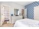 Bedroom featuring blue geometric wallpaper and ensuite bathroom with blue accents and shower curtain at 217 Jones Hill Rd, Holly Springs, NC 27540