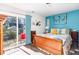 Bedroom featuring a wood bed, balcony access, and vibrant turquoise accent wall at 217 Jones Hill Rd, Holly Springs, NC 27540