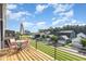 Inviting deck with sleek railing offers community views and outdoor seating with a table and umbrella at 217 Jones Hill Rd, Holly Springs, NC 27540