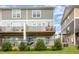 Townhome with two-story exteriors and backyard patios and decks for each unit, creating private outdoor spaces at 217 Jones Hill Rd, Holly Springs, NC 27540