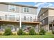 Townhome with two-story exteriors and backyard patios and decks for each unit, creating private outdoor spaces at 217 Jones Hill Rd, Holly Springs, NC 27540