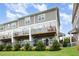 Townhome with two-story exteriors and backyard patios and decks for each unit, creating private outdoor spaces at 217 Jones Hill Rd, Holly Springs, NC 27540