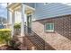 Charming home exterior with brick accents, complemented by a welcoming porch and stylish front door at 217 Jones Hill Rd, Holly Springs, NC 27540