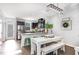 Open kitchen and dining area featuring a rustic wood table and stainless steel appliances at 217 Jones Hill Rd, Holly Springs, NC 27540