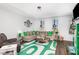 Bright living room boasts modern decor, a large sectional sofa, and a stylish green accent rug at 217 Jones Hill Rd, Holly Springs, NC 27540