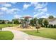 Community playground with various play structures, benches, and a safe, cushioned ground for children at 217 Jones Hill Rd, Holly Springs, NC 27540