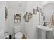 Stylish half bathroom with decorative shelving and a pedestal sink at 225 Alcock Ln, Youngsville, NC 27596