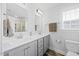 Elegant bathroom featuring a white double vanity, framed mirrors, and modern fixtures at 225 Alcock Ln, Youngsville, NC 27596