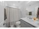 Well-lit bathroom featuring a grey vanity with granite countertops and modern fixtures at 225 Alcock Ln, Youngsville, NC 27596
