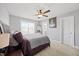 A primary bedroom features a ceiling fan, and an ensuite bathroom beyond the door at 225 Alcock Ln, Youngsville, NC 27596