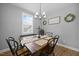 Charming dining room with a wooden table set and natural light at 225 Alcock Ln, Youngsville, NC 27596