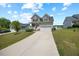Inviting two-story home with a well-manicured lawn and a long concrete driveway at 225 Alcock Ln, Youngsville, NC 27596