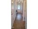 Hallway with hard wood floors leading to the front door at 225 Alcock Ln, Youngsville, NC 27596