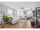 Bright living area with an expansive white couch, ceiling fan, and hardwood flooring at 225 Alcock Ln, Youngsville, NC 27596
