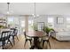 Bright, open-concept living area with a round dining table, hardwood floors, and natural light at 225 Alcock Ln, Youngsville, NC 27596