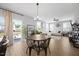 Bright, open-concept living area with a round dining table, hardwood floors, and natural light at 225 Alcock Ln, Youngsville, NC 27596
