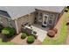 Aerial view of the backyard featuring patio with brick accent wall and lush landscaping at 232 Shady Hollow Ln, Garner, NC 27529