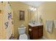This bathroom features a single sink, a toilet, and yellow walls at 232 Shady Hollow Ln, Garner, NC 27529