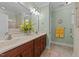 This primary bathroom has double sinks, wood cabinets, and a large mirror at 232 Shady Hollow Ln, Garner, NC 27529