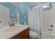 This bathroom features a single sink, a shower over tub, and calming blue walls at 232 Shady Hollow Ln, Garner, NC 27529