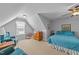 This large bedroom features a queen bed, two sitting chairs, and a sloped ceiling at 232 Shady Hollow Ln, Garner, NC 27529