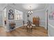 Cozy dining area features wood floors, decorative shelving and light fixture and a view to the outside at 232 Shady Hollow Ln, Garner, NC 27529