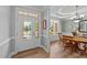Welcoming foyer with stained glass door and sidelights, leading to a dining room with natural light and wood floors at 232 Shady Hollow Ln, Garner, NC 27529