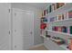 This hallway features built in shelving full of books and a white door at 232 Shady Hollow Ln, Garner, NC 27529