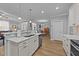 This home features a bright kitchen with stainless steel appliances, white cabinetry, and wood floors at 232 Shady Hollow Ln, Garner, NC 27529