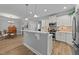 An eat-in kitchen boasts granite countertops, stainless appliances, white cabinetry, and pendant lighting at 232 Shady Hollow Ln, Garner, NC 27529