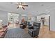 Spacious living room featuring hardwood floors, leather seating, open floor plan, and easy access to adjacent rooms at 232 Shady Hollow Ln, Garner, NC 27529