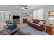 Comfortable living room featuring a fireplace, hardwood floors, leather seating, and soft lighting, with open floor plan at 232 Shady Hollow Ln, Garner, NC 27529