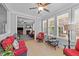 Bright and airy sunroom featuring ample natural light, neutral tile flooring, comfortable seating, and access to the living room at 232 Shady Hollow Ln, Garner, NC 27529