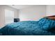 Primary bedroom features a window with white blinds and a made bed with blue bedding at 2406 Lily Dr, Haw River, NC 27258