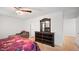 Bedroom featuring a comfortable armchair, wooden dresser and mirror, and soft carpet at 2406 Lily Dr, Haw River, NC 27258