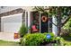 Inviting front door with seasonal wreath and security system sign at 2406 Lily Dr, Haw River, NC 27258