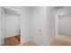 Bright hallway with white walls and white trim and two different types of flooring at 2406 Lily Dr, Haw River, NC 27258